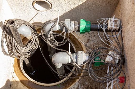 A residential backup sump pump system with wiring around it that needs to be installed by a plumber in Fremont Hills, MO.